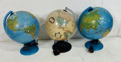 A collection of three light-up globes