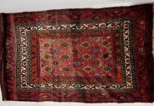 A hand woven Eastern red ground rug. 145cm x 240cm
