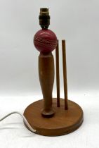 A cricket themed lamp, height 35cm