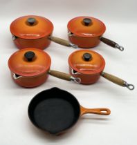 A collection of five Le Creuset pans including numbers 22, 20, 18 & 16 saucepans and number 20