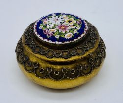 A continental silver gilt pill box with micro mosaic decoration to lid