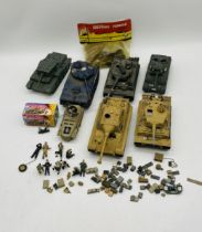 A collection of military tanks (one battery operated) and armoured toy models, along with a small