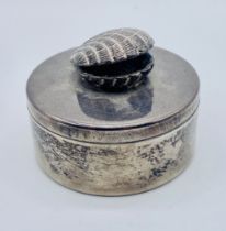 A hallmarked silver lidded pot with scallop shell finial