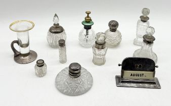 A collection of silver topped scent bottles and dressing table pots etc.