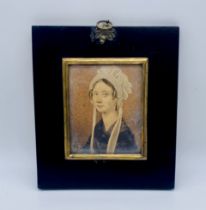 An unsigned miniature watercolour of a lady wearing a bonnet, dated to reverse 1836