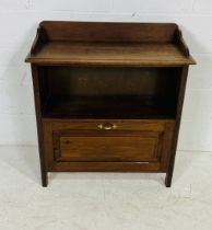A turn of the century cabinet with drop down drawer