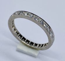 A diamond full eternity ring set in white metal (believed to be 18ct white gold)