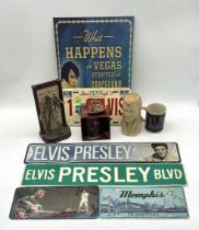 A large collection of Elvis Presley memorabilia including books, magazines, pin badges etc