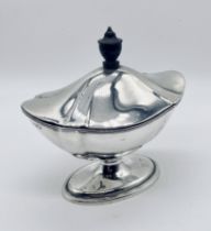 A hallmarked silver boat shaped lidded sucriere on oval foot, London 1897