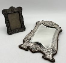 A large hallmarked silver Art Nouveau mirror A/F along with a hallmarked silver photo frame