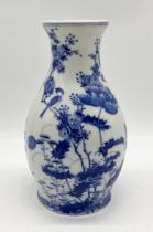 A Japanese blue and white vase decorated with floral and bird motif, character marks to base