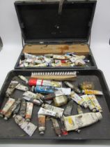 A vintage wooden case containing various oil paints, etc.