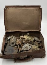 A collection of various vintage locks and keys in leather case