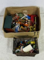 A collection of toy farmyard accessories including buildings, fencing, show jumping, strawbales,