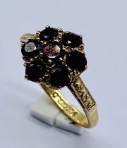 A garnet cluster ring set in 9ct gold