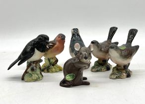 A collection of Beswick birds including a Stonechat, Nuthatch, Whitethroat (x 2), Bulfinch and a