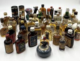 A collection of mainly whisky and rum alcohol miniatures including Crawfords, Glenfiddich, Whyte &