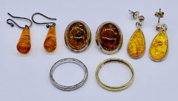 A small collection of 925 silver jewellery set with amber along with two wedding bands
