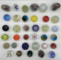 A large collection of glass paperweights.