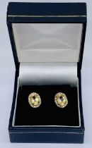 A pair of citrine and diamond cluster earrings set in 9ct gold