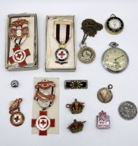 A collection of miscellaneous items including vintage Red Cross medals, Novice pocket watch,