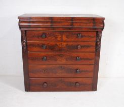 A Victorian mahogany chest of seven drawers, with turned handles and carved decoration (top of chest