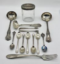 A collection of silver coffee spoons including a Rolex spoon, ladle and silver topped dressing table