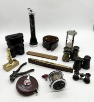A collection of various items including binoculars, brass ice cream wafer press, Avon Shaw fishing