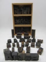 A collection of vintage letterpress wooden printing blocks