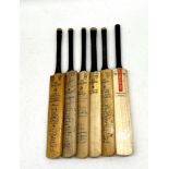A collection of miniature cricket bats including a signed "Kent John Player Champions" including