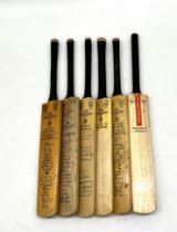 A collection of miniature cricket bats including a signed "Kent John Player Champions" including