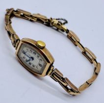 A ladies 9ct gold wristwatch on 9ct gold strap, total weight including movement 15.3g