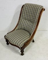 A Victorian mahogany nursing chair with serpentine front