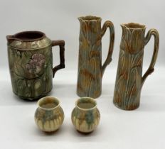 A collection of jugs and vases including a pair marked "Tulip" to base, a large Majolica jug with