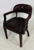 An oxblood Chesterfield office chair with button-back detailing