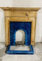 An antique pine fire surround with blue tiled inset and hearth. 123cm x 134cm