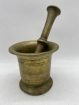 A large 18th/19th century bronze pestle and mortar, mortar height 15cm, pestle length 29cm