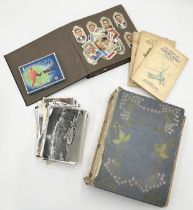 A collection of vintage postcards in album and loose along with a small collection of cigarette