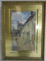 A gilt framed watercolour signed Hubert Coop of a town scene with a girl playing with a hoop, 49cm x
