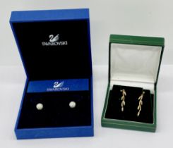 A pair of 9ct gold drop earrings (weight 1g) along with a pair of Swarovski earrings