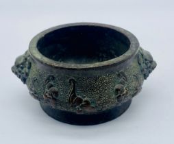 A Japanese bronze censer with temple lion handles and decorated with bats over floral design, four