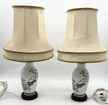 A pair of Famille Rose Chinese lamps decorated with cherry blossom and bird motif