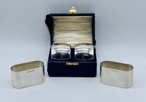 A pair of cased silver napkin rings along with another pair, total weight 188.1g