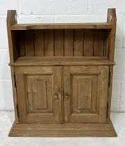 A small wall hanging pine cupboard with shelf above