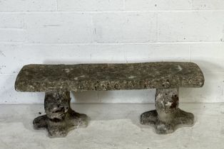 A weathered reconstituted stone garden bench with lion shaped supports - 116cm x 45cm, height 38cm