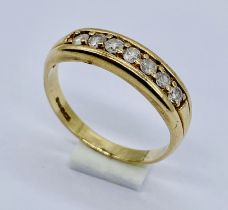 A 9ct gold half eternity ring set with 7 diamonds