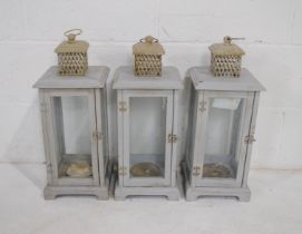 Three painted wooden candle lanterns