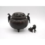A 19th century oriental bronze twin-handle tripod Censer, with relief decoration depicting dragons