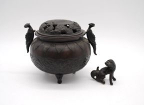 A 19th century oriental bronze twin-handle tripod Censer, with relief decoration depicting dragons