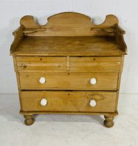 A Victorian pine chest of four drawers with gallery top - Height 105cm, width 99cm, depth 53cm